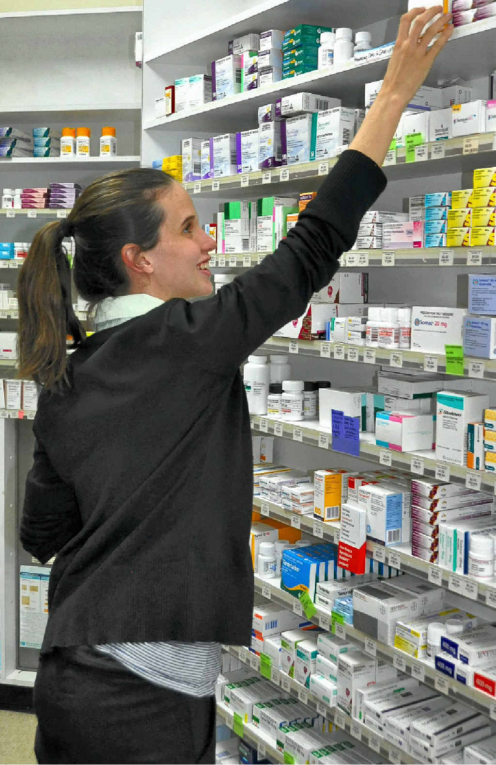 Intern pharmacist Claire Purcell finds a customer’s medicine. Intern pharmacist Claire Purcell finds a customer’s medicine.
